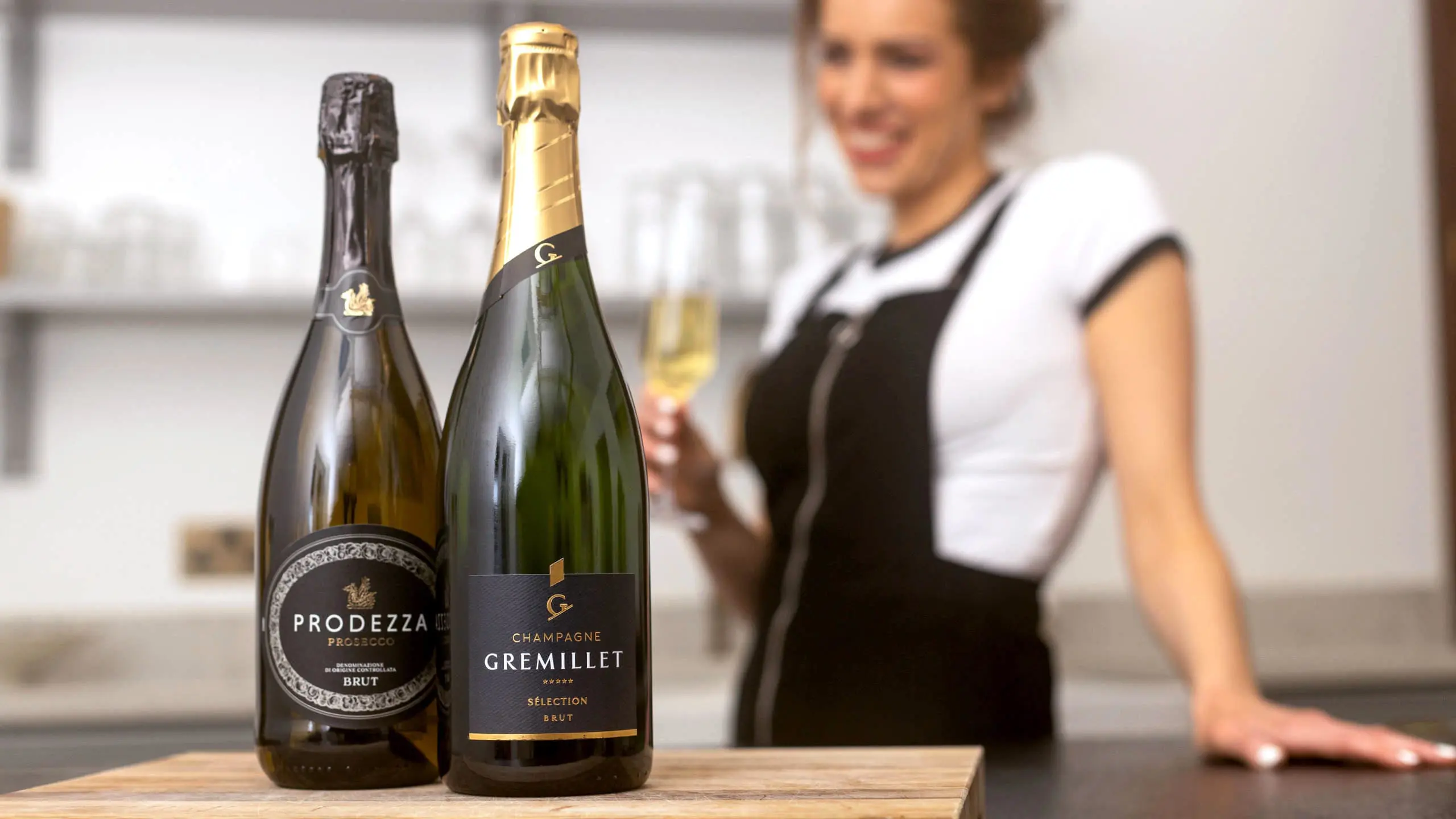 Bottle-of-Prosecco-next-to-bottle-of-Champagne-on-a-kitchen-worktop-2560x1440.webp